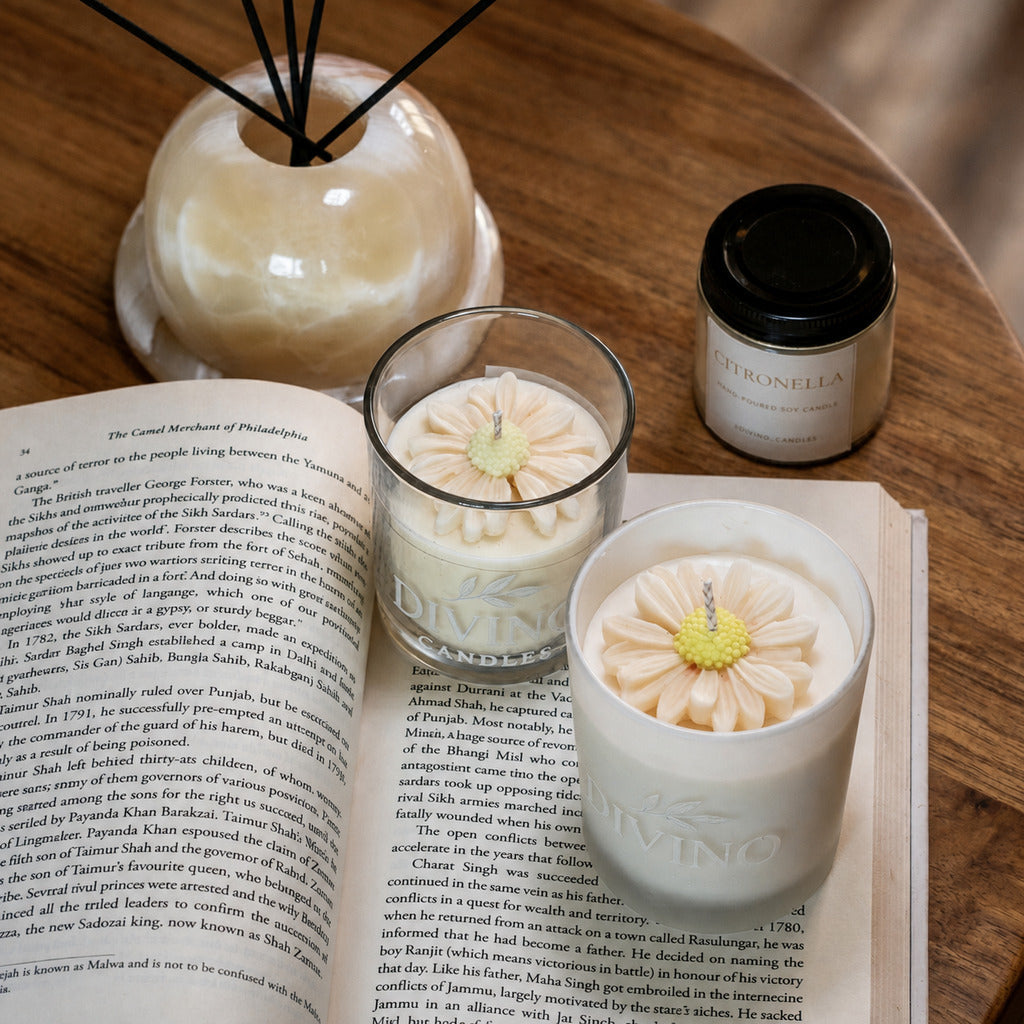 Citronella candles arranged with a book and diffuser