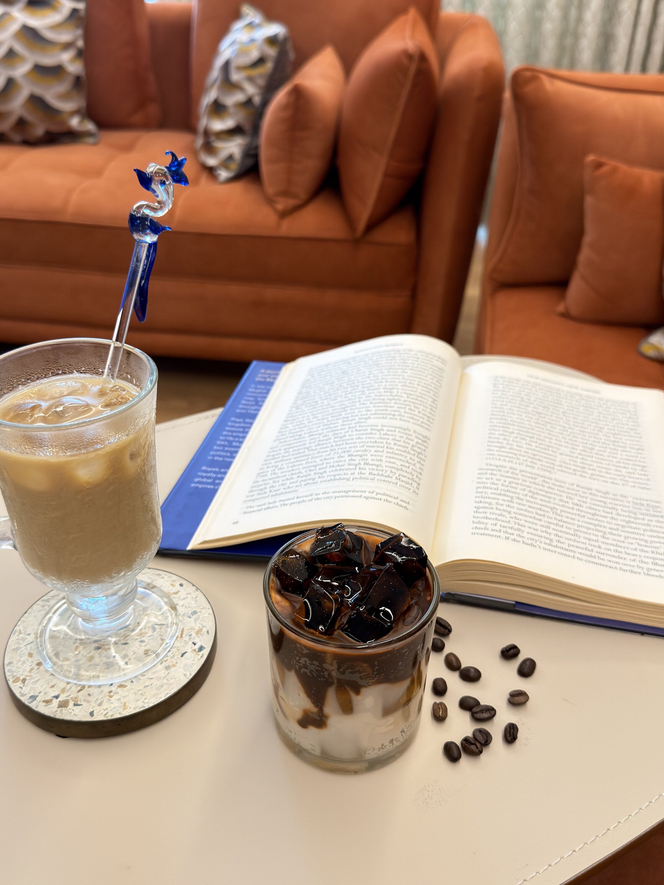 Cold coffee candle displayed beside a real glass of iced coffee