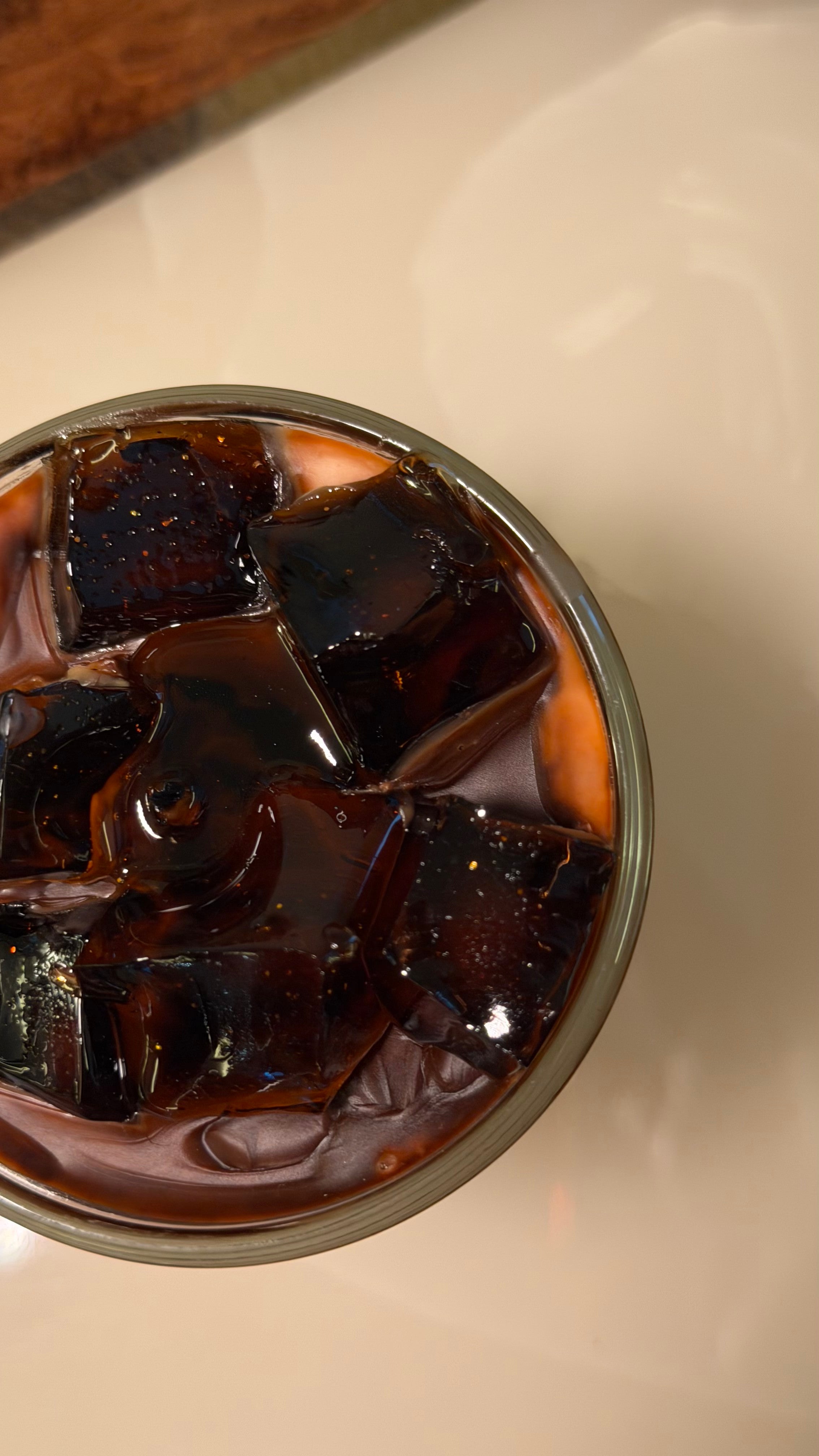 Top view of translucent coffee-coloured gel wax ice cubes